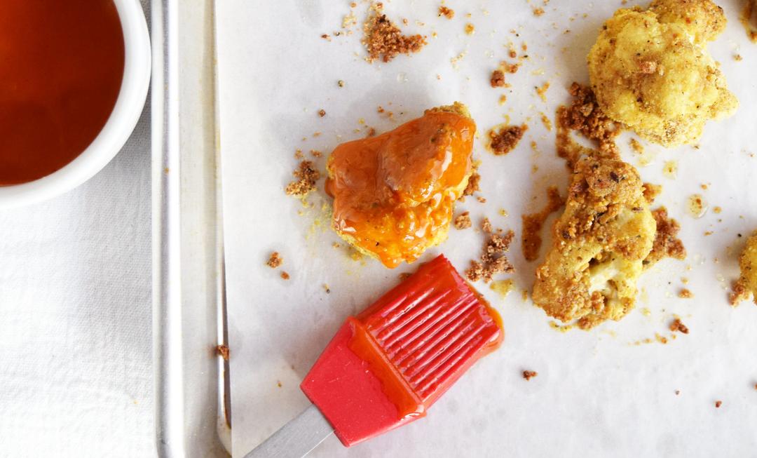 partly baked cauliflower florets coated in buffalo sauce