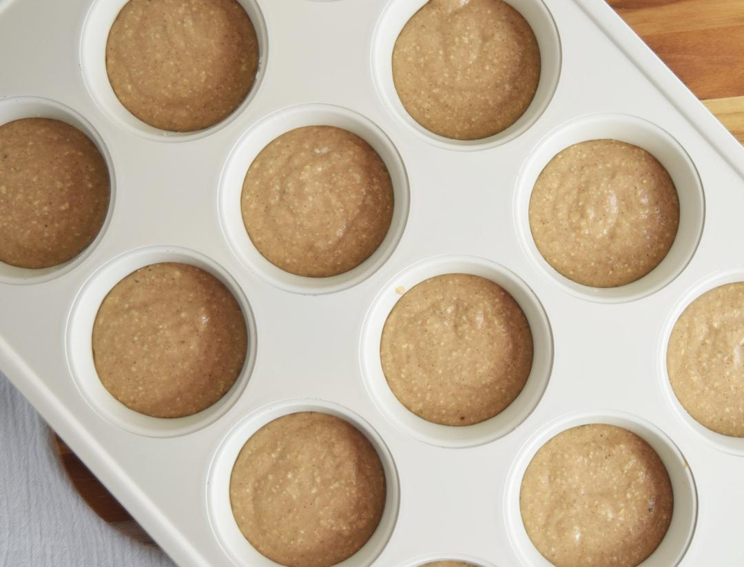 banana muffin batter in muffin pan