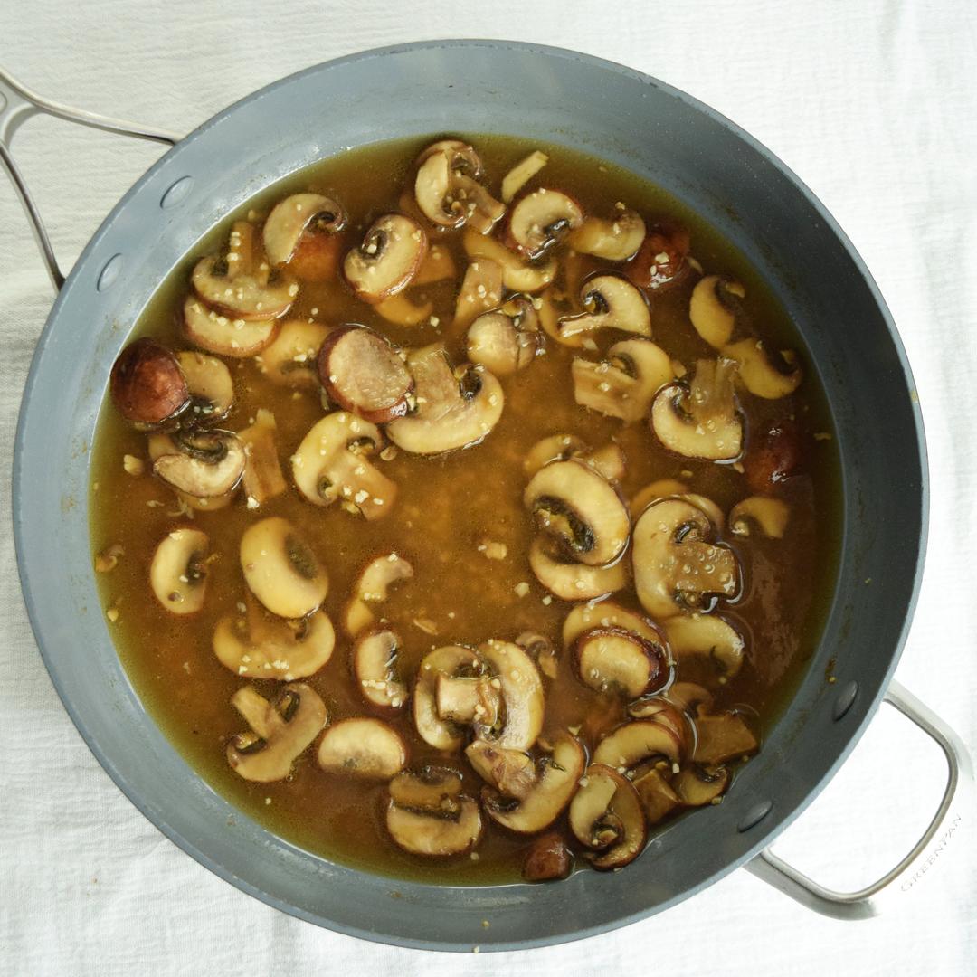 mushrooms and garlic and marsala wine in saute pan