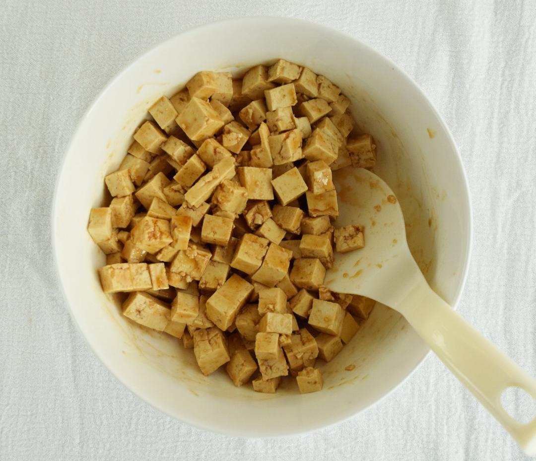 cubed tofu soaked in marinade in a bowl